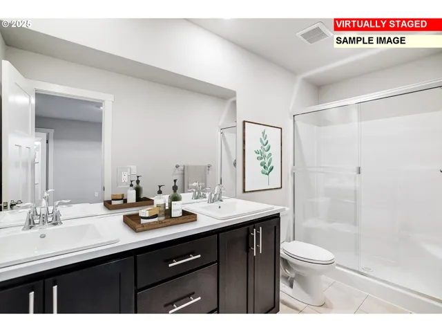 a bathroom with a sink a toilet a shower and a mirror