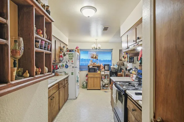 a kitchen with stove and cabinets