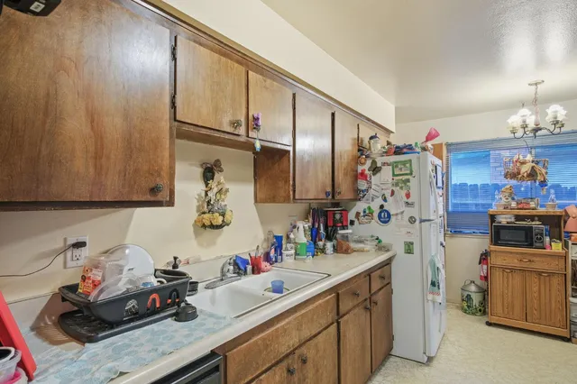 a kitchen with sink cabinets and appliances