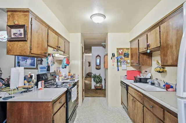 a kitchen with stainless steel appliances granite countertop a sink stove and cabinets