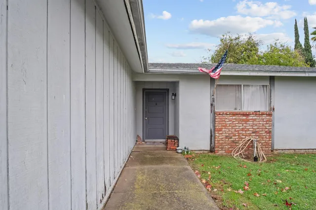 a front view of a house with a garden
