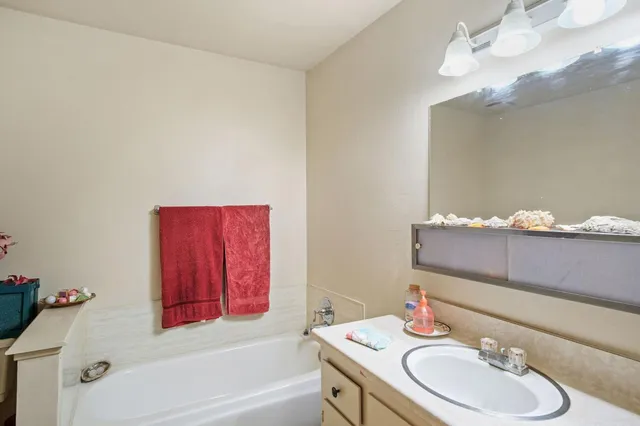 a bathroom with a sink vanity tub and toilet