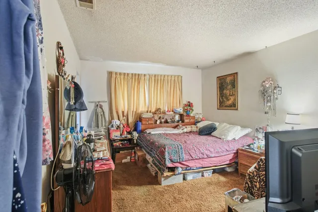 a bedroom with furniture and a chandelier