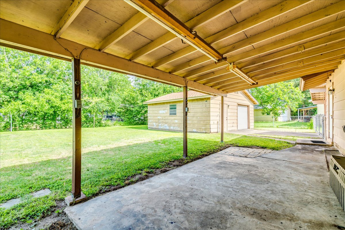 6626 Isabelle Drive Austin, TX 78752 - Photo 23 of 27 Covered concrete patio extending to a detached garage