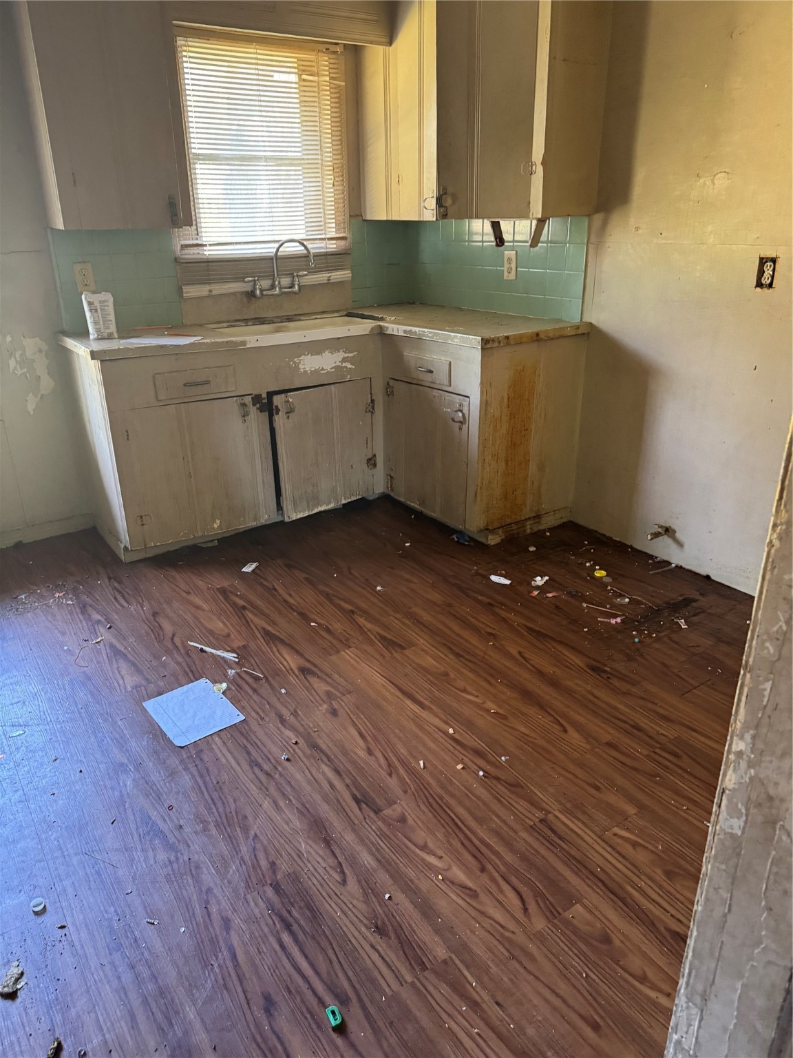 5325 Longmeadow Street Houston, TX 77033 - Photo 10 of 32 a kitchen with granite countertop a sink cabinets and a wooden floor