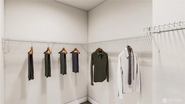a view of walk in closet with clothes and shoes