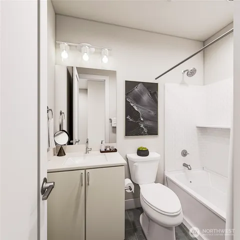 a bathroom with a granite countertop toilet sink and mirror