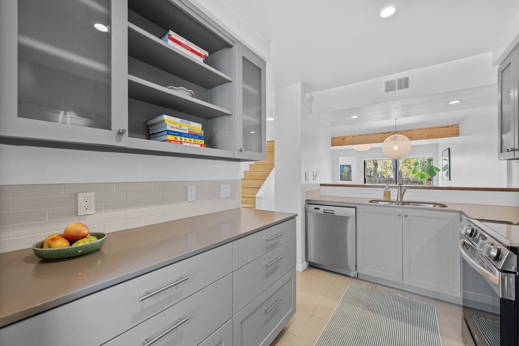 3801 Menchaca Road, Unit 13 Austin, TX 78704 - Photo 1 of 1 a kitchen with stainless steel appliances a sink and a stove