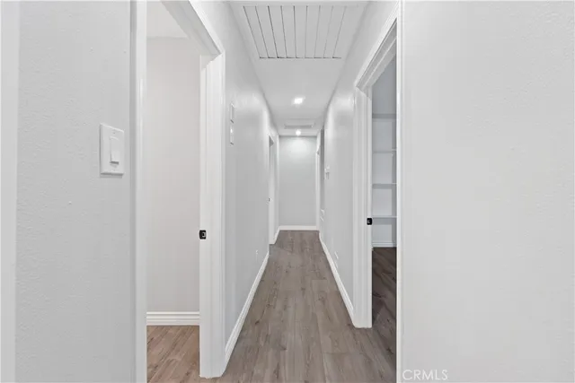 a view of a hallway with wooden floor