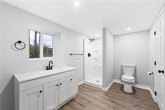 a bathroom with a double vanity sink toilet and shower