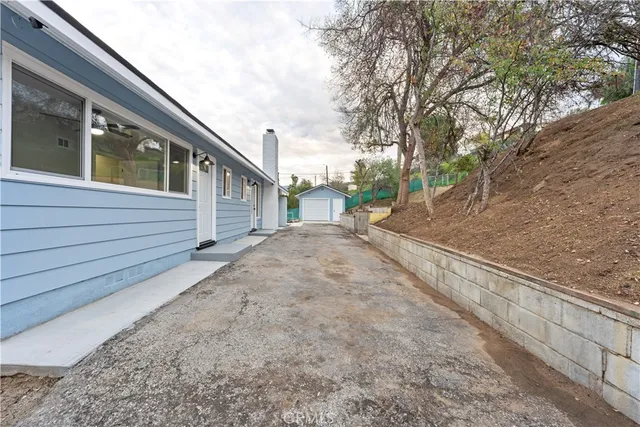 a view of a house with a large tree