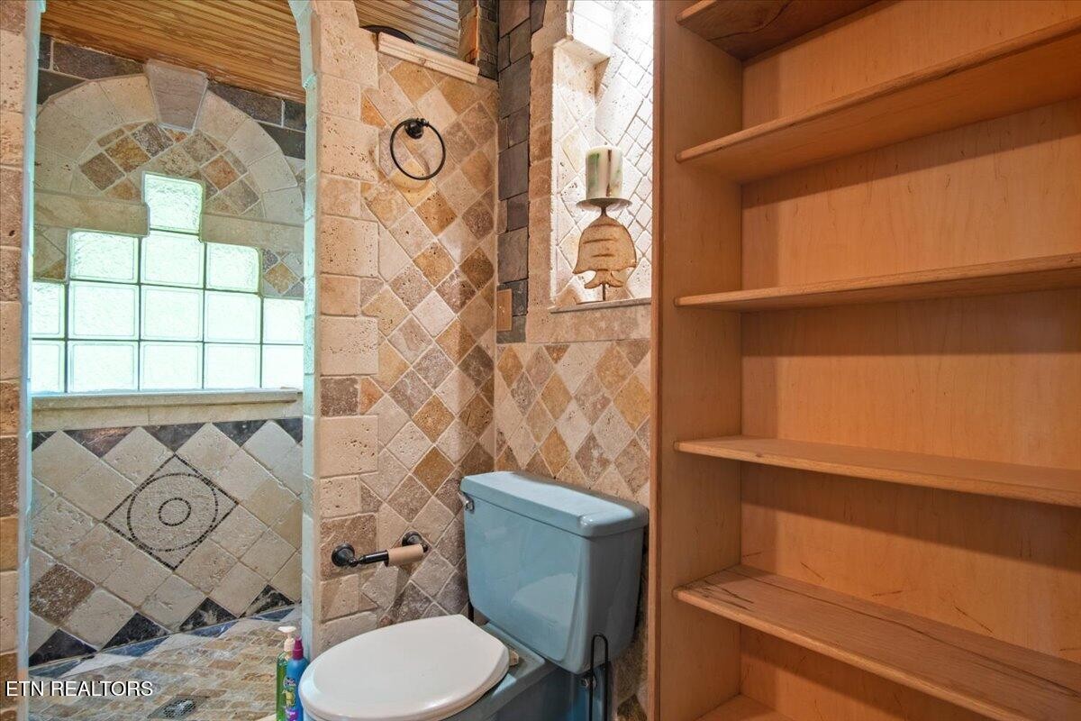 103 Baltimore Drive Oak Ridge, TN 37830 - Photo 29 of 45 a bathroom with a toilet and a shower curtain