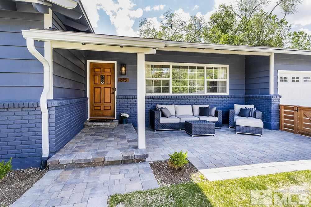 815 Lahontan Way Reno, NV 89509 - Photo 3 of 20 a view of a patio with table and chairs with wooden floor and fence