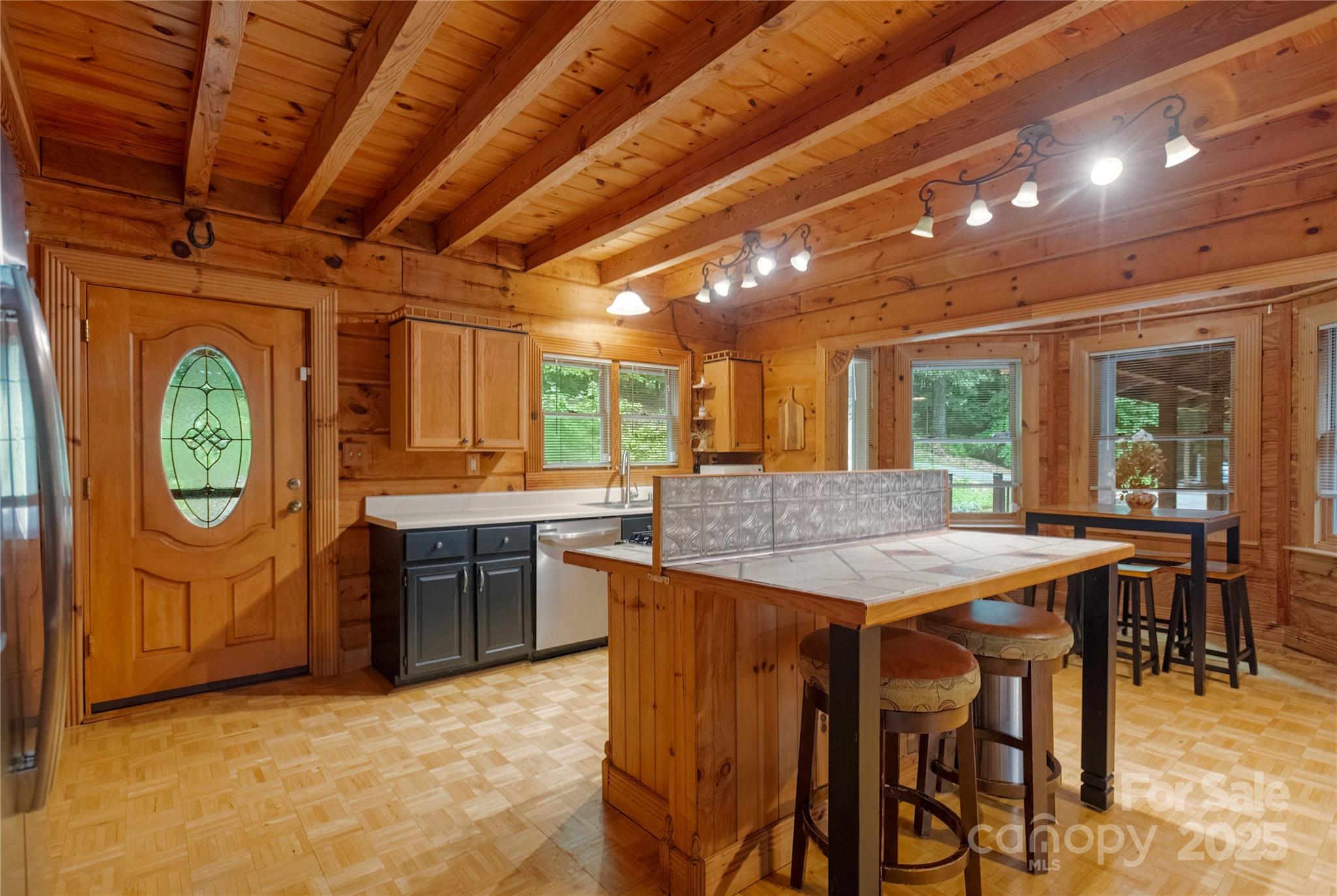720 Potneck Road Salisbury, NC 28147 - Photo 12 of 48 a dining hall with stainless steel appliances granite countertop a stove a sink dishwasher and chairs with wooden floor