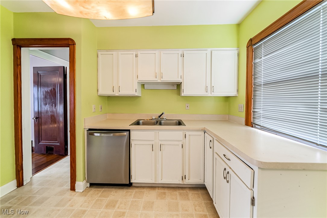 6711 Forest Avenue Parma, OH 44129 - Photo 13 of 33 Kitchen featuring stainless steel dishwasher, white cabinets, and light countertops