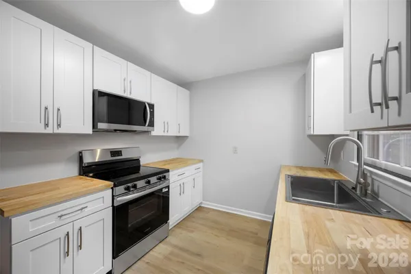 a room with a sink cabinets and utility room
