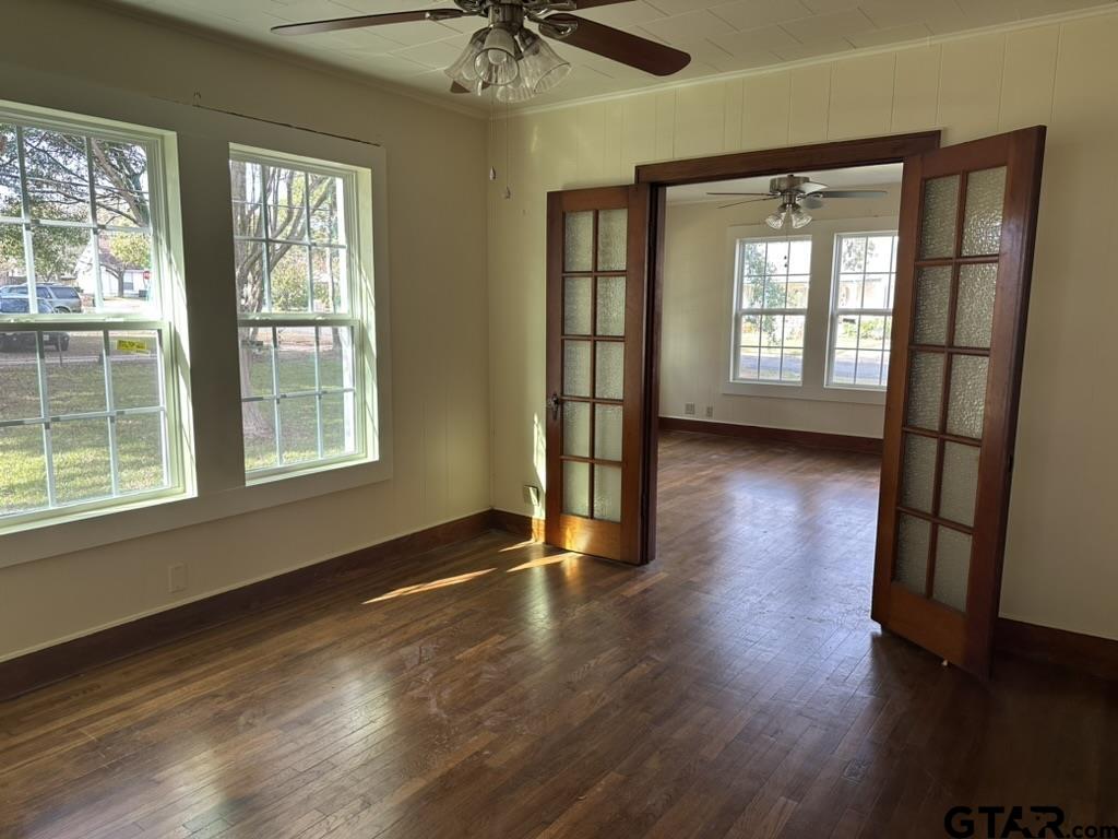 1717 East Houston Street Tyler, TX 75702 - Photo 5 of 10 a view of an empty room with a window and wooden floor