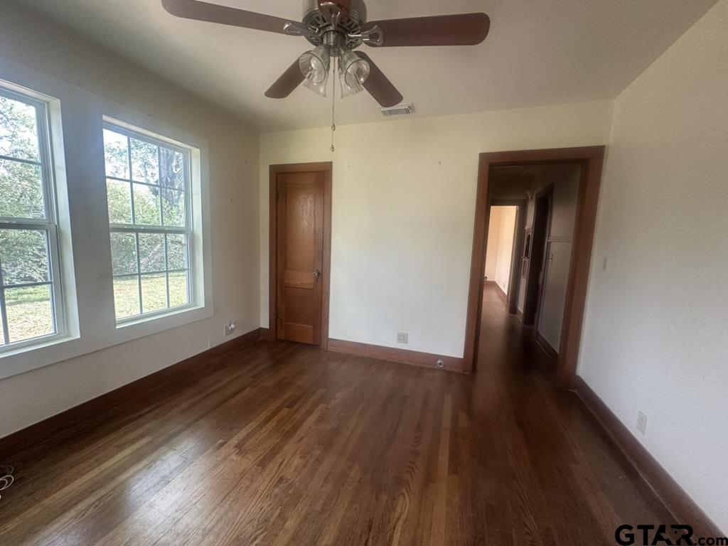 1717 East Houston Street Tyler, TX 75702 - Photo 10 of 10 a view of an empty room with wooden floor and a window
