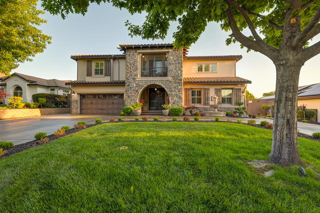 a front view of a house with a yard table and chairs