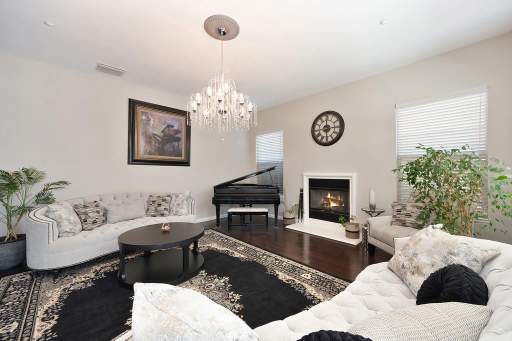 1721 Bella Circle Lincoln, CA 95648 - Photo 11 of 66 a living room with furniture a table and a fireplace