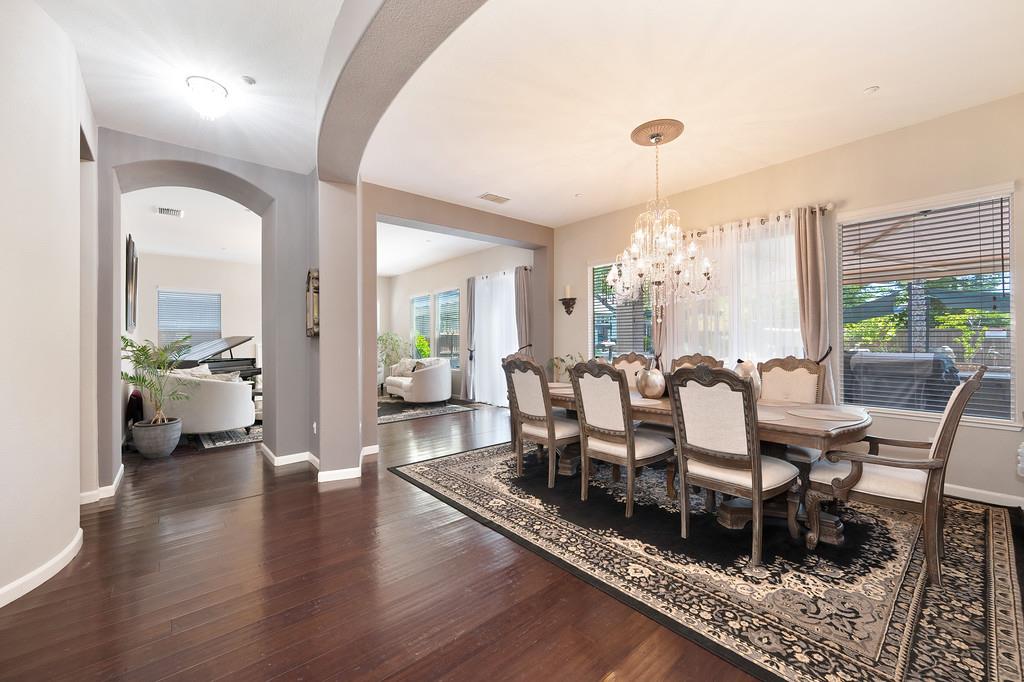 1721 Bella Circle Lincoln, CA 95648 - Photo 12 of 66 a dining room with wooden floor and a floor to ceiling window
