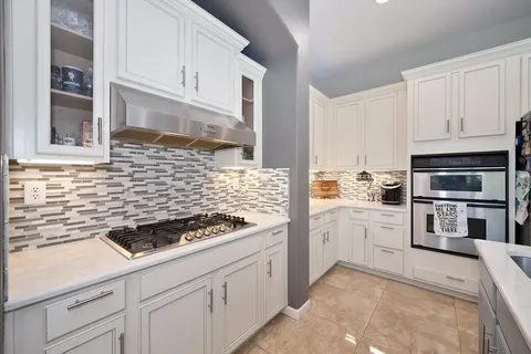 a view of a dining room with furniture and a table and wooden floor