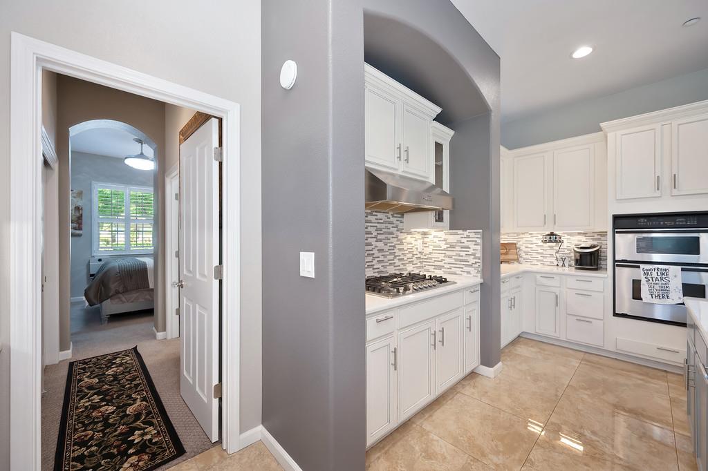 1721 Bella Circle Lincoln, CA 95648 - Photo 19 of 66 a kitchen with white cabinets and appliances