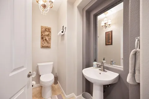 a view of a patio with couches and a table and chairs with plants and palm trees