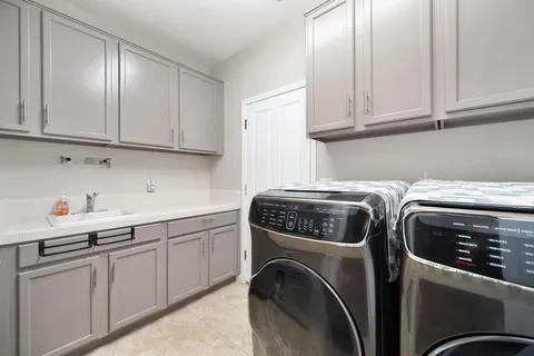 a view of a house with backyard and sitting area