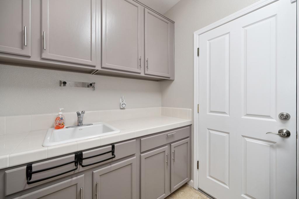 1721 Bella Circle Lincoln, CA 95648 - Photo 50 of 66 a kitchen with white cabinets and a sink