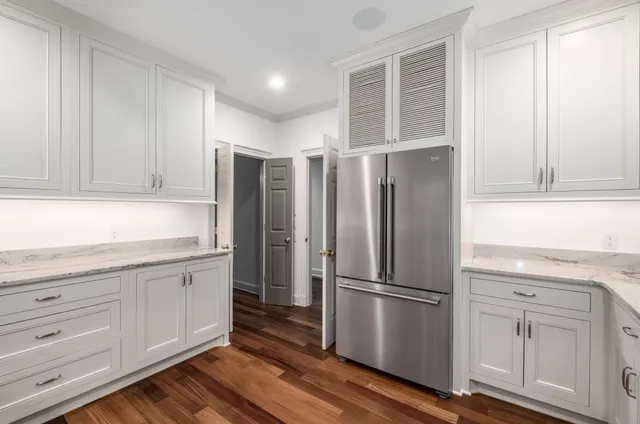 a kitchen with stainless steel appliances a refrigerator and cabinets