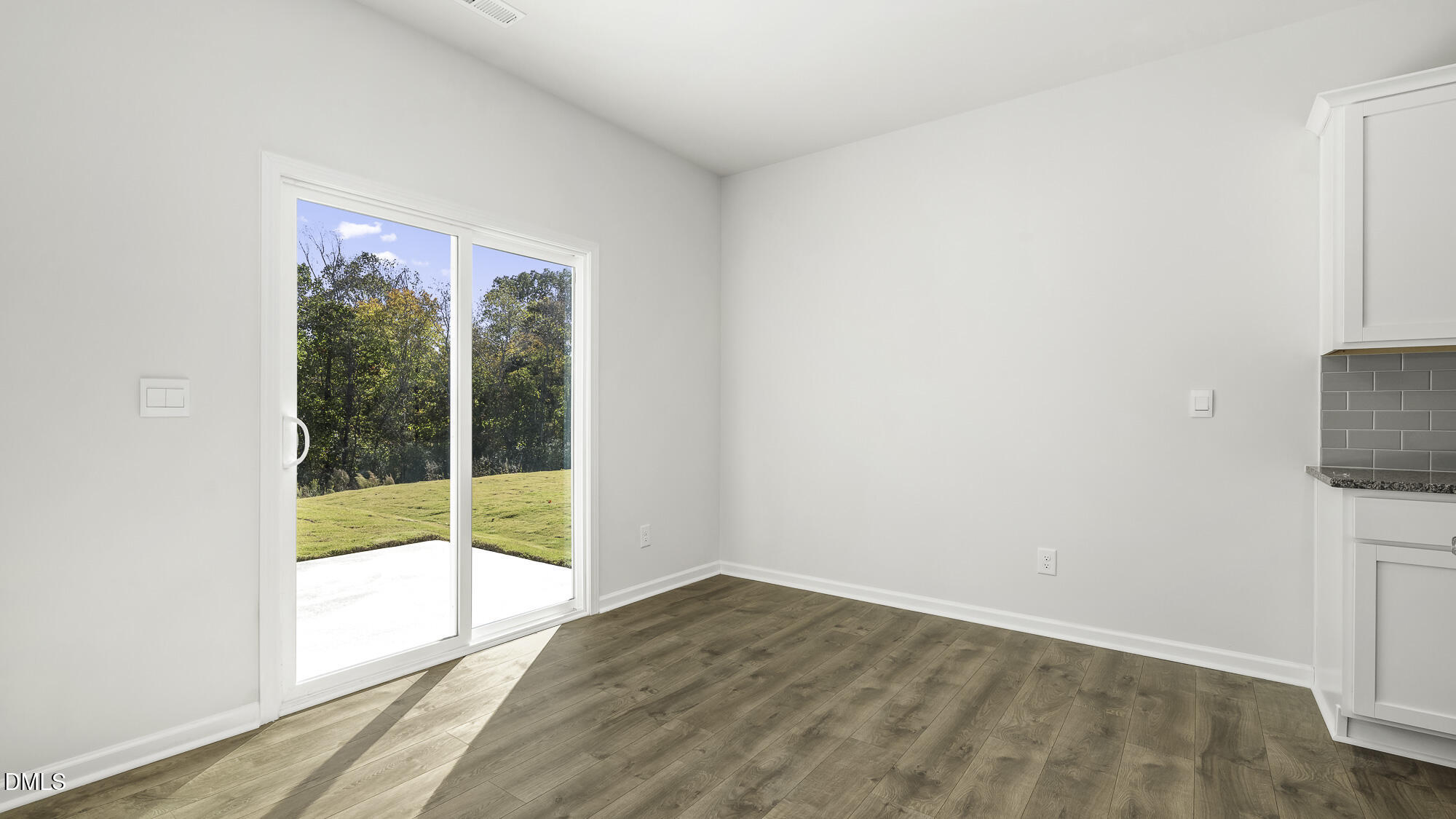 1376 Lansdowne Drive Mebane, NC 27302 - Photo 7 of 22 a view of an empty room with wooden floor and a window