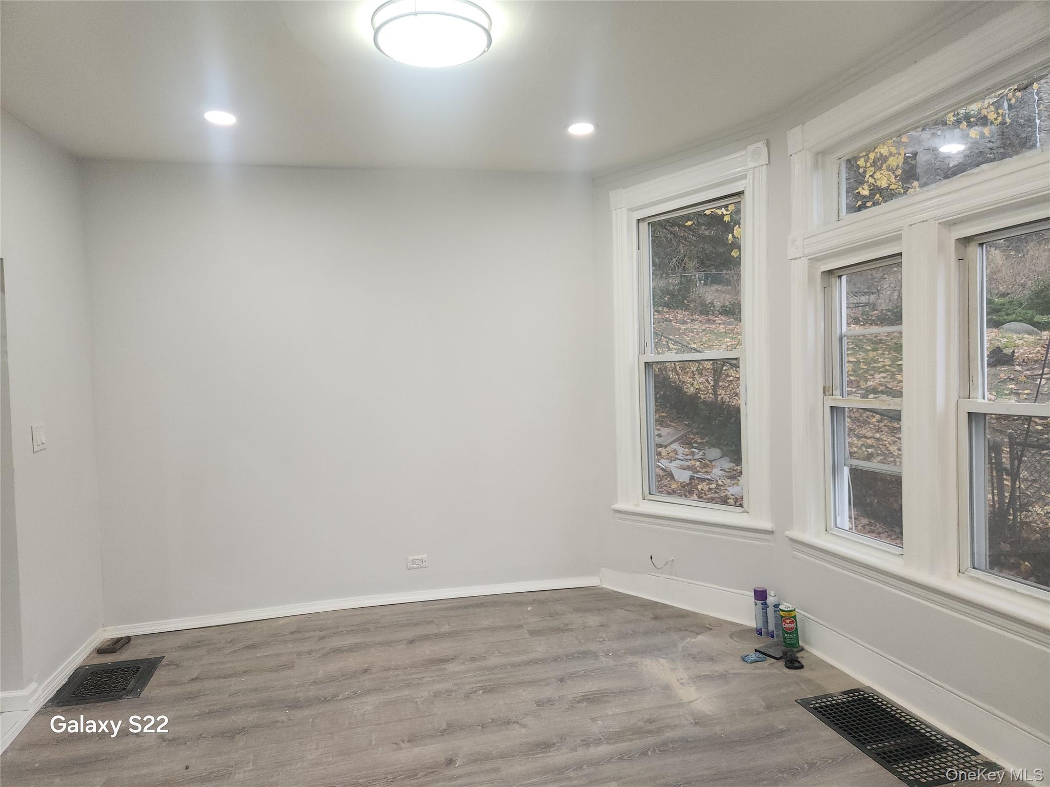 38 Cornell Avenue Yonkers, NY 10705 - Photo 7 of 11 an empty room with wooden floor and windows