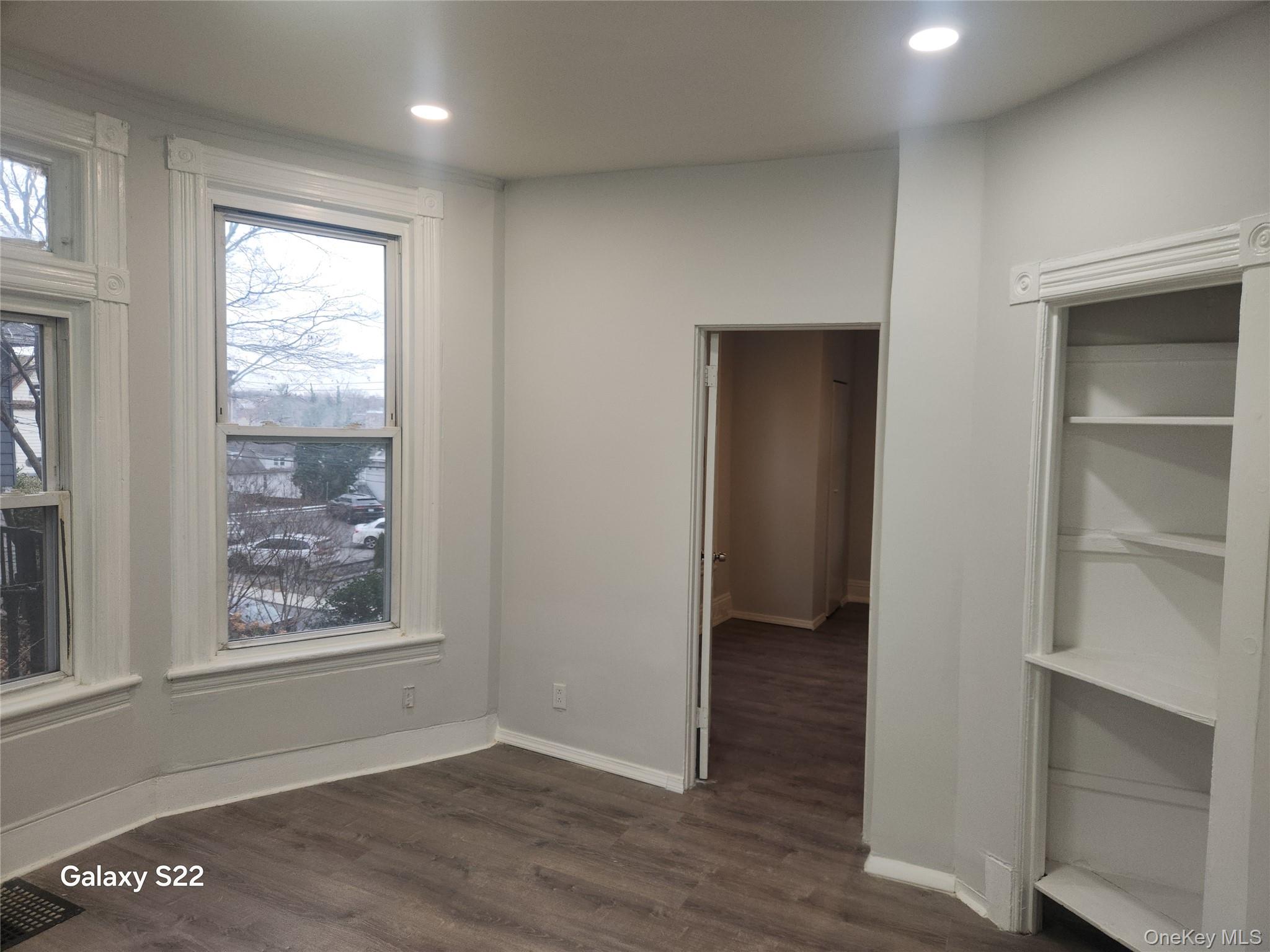 38 Cornell Avenue Yonkers, NY 10705 - Photo 8 of 11 an empty room with wooden floor and windows