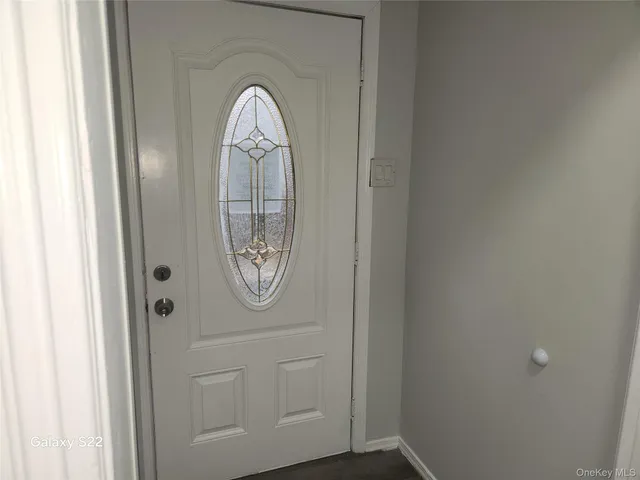 a front view of a house with wooden floor and a door