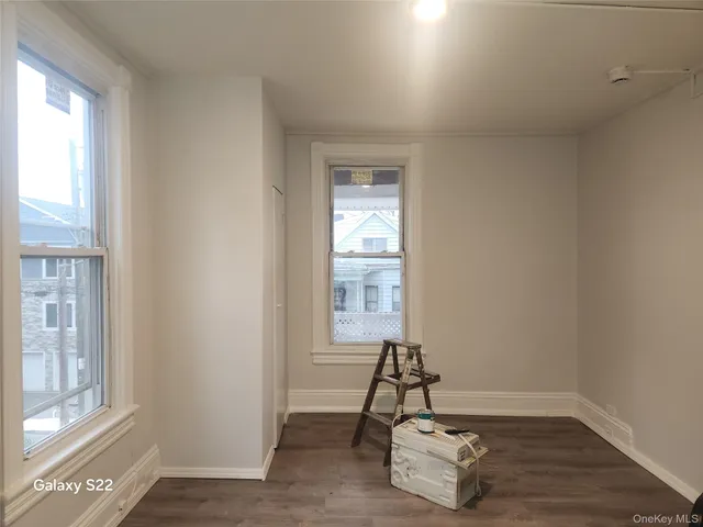 a room with a window and a wooden floor