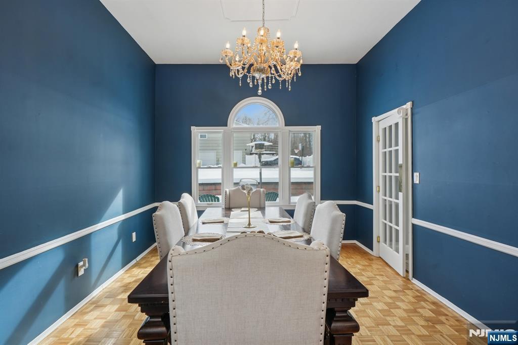 25 Nathan Way Wayne, NJ 07470 - Photo 11 of 36 a view of a dining room with furniture a chandelier and wooden floor