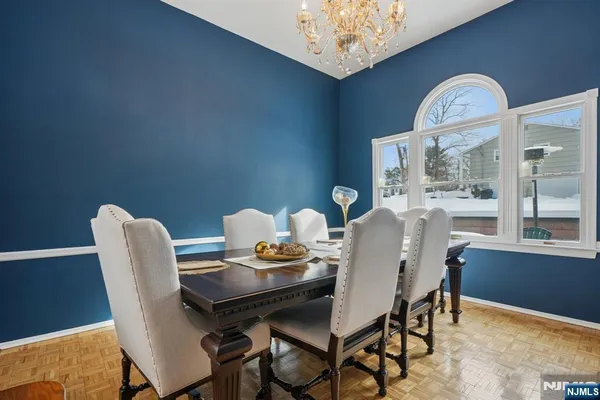 a kitchen with stainless steel appliances a table and chairs in it