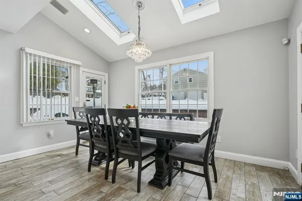 a kitchen with a stove a sink a dining table and chairs