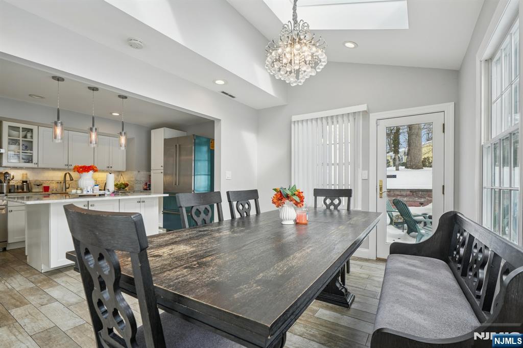 25 Nathan Way Wayne, NJ 07470 - Photo 14 of 36 a dining room with furniture a chandelier and wooden floor