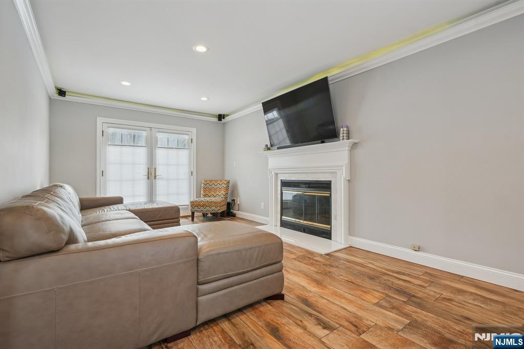 25 Nathan Way Wayne, NJ 07470 - Photo 22 of 36 a living room with furniture a fireplace and a flat screen tv
