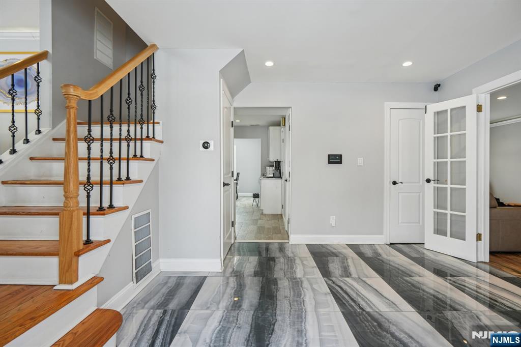 25 Nathan Way Wayne, NJ 07470 - Photo 5 of 36 a view of a hallway with wooden floor and staircase