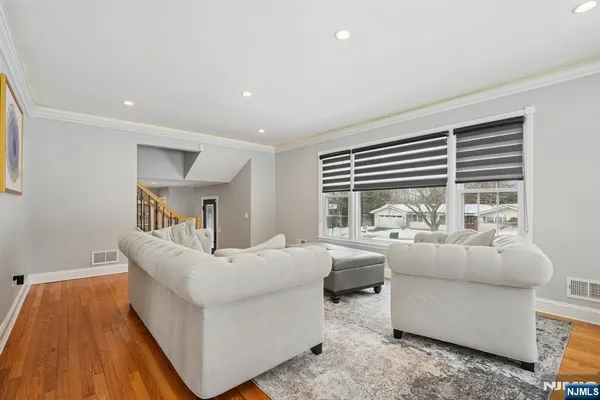 a view of a dining room with furniture a chandelier and wooden floor
