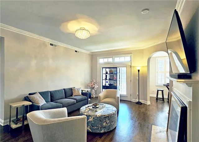 a living room with furniture a fireplace and a flat screen tv