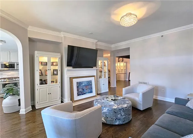 a kitchen with a stove a sink dining table and chairs
