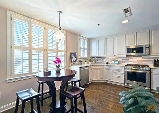 a kitchen with stainless steel appliances granite countertop a sink stove oven and refrigerator