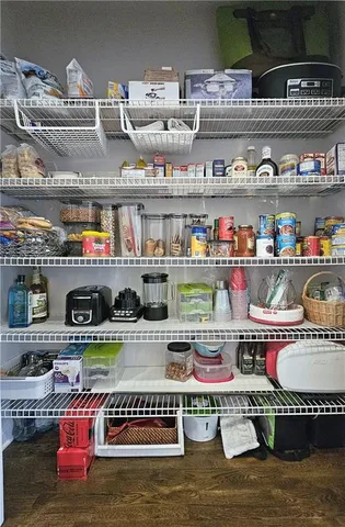 a bedroom with a bed couch and a flat tv screen on a dresser