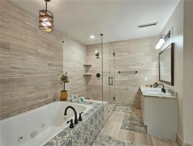 a bathroom with a sink a bathtub and a shower