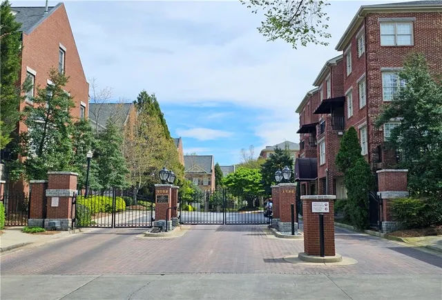 a sign board with buildings in the background