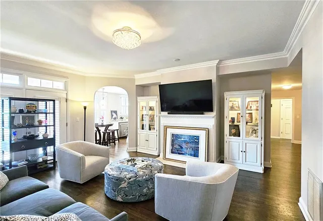 a living room with fireplace furniture and a flat screen tv